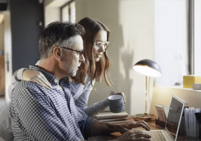father with daughter at computer